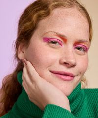detalhes da maquiagem da modelo usando o lapis delineador rosa e laranja nos olhos